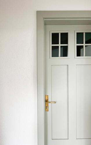 a white door with a handle and a window at Haus Münsterblick in Reichenau