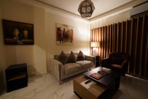 a living room with a couch and a chair at Home Suites Boutique Hotel in Freetown