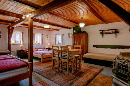 a room with a table and chairs and a bedroom at Chalupa Bedřichov in Bedřichov