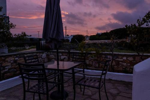 a table and chairs with an umbrella on a patio at Martha's filoxenia in Drios