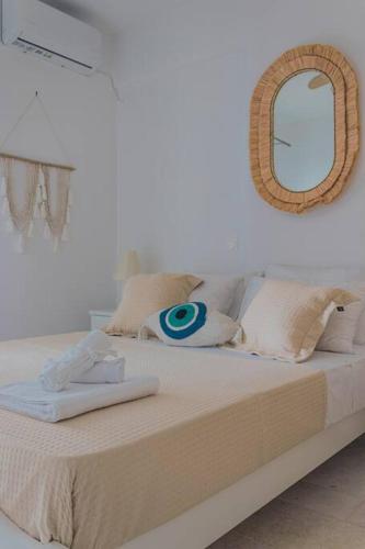 a bedroom with a bed with a mirror on the wall at Martha's filoxenia in Drios