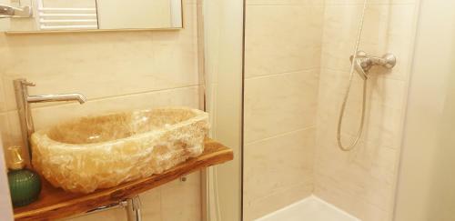 a bathroom with a bowl sink and a shower at Apartament Na Wydmie, garaż + ładowarka EV in Ustka