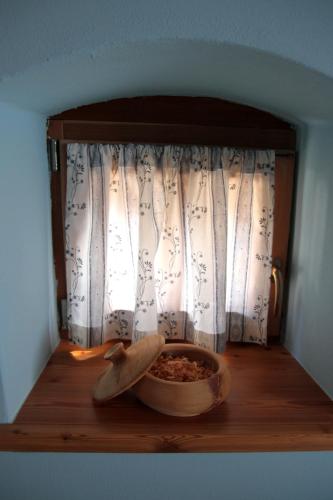 a bowl of food sitting on a table in front of a window at B&B Chalet Dolomiti in Sant’Orsola