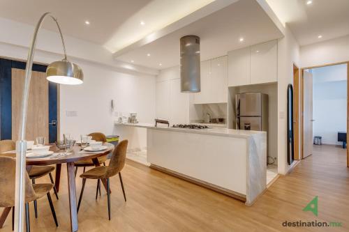 a kitchen and dining room with a table and chairs at Lovely & Spacious Apartment with Pool & Gym in La Condesa - Icon in Mexico City
