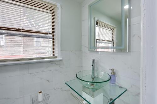 a bathroom with a glass sink and a mirror at Jersey City Vacation Rental about 8 Mi to NYC! in Jersey City