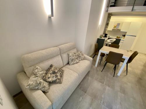 a living room with a couch and a table at Loft Nineteen Apartment in La Spezia