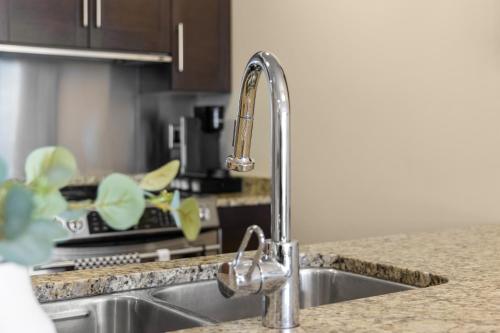 a kitchen sink with a faucet in a kitchen at Aria Escape by Iris Properties! in Victoria