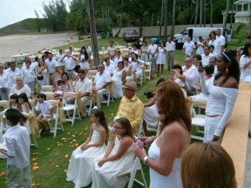 a group of people sitting in chairs at a wedding at The Views Will Take Your Breath Away - Romantic Villa on the Beach in Arecibo
