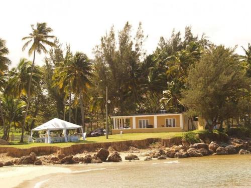 a house on the shore of a beach at The Views Will Take Your Breath Away - Romantic Villa on the Beach in Arecibo