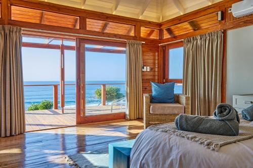 a bedroom with a bed and a view of the ocean at Aloha 10 I 4Bed Villa with Stunning Sea View Pool in Ponta Mamoli
