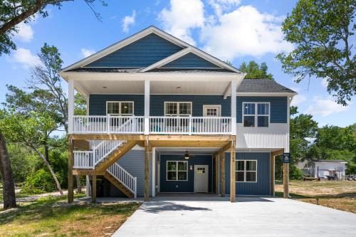 a home with a blue and white house at Ferry House - Upper Unit in Supply