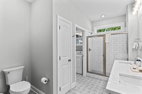 a bathroom with a toilet and a sink and a shower at Ferry House - Upper Unit in Supply