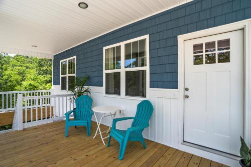 a porch with two blue chairs and a table at Ferry House - Upper Unit in Supply