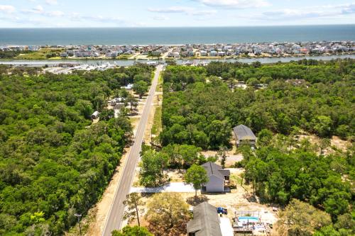 an aerial view of a road with trees and the ocean at Ferry House - Upper Unit in Supply