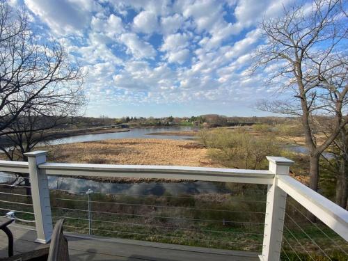 a view of a river from a white fence at Salmon River View in Pulaski