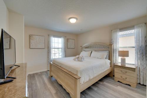 a bedroom with a large bed and a television at Less Than 10 Mi to Disney Prime Resort Villa with Pool in Davenport
