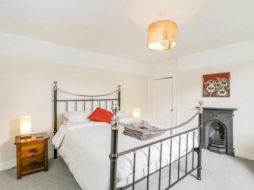 a bedroom with a bed and a fireplace at Viaduct House in Lydbrook