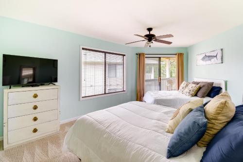 a bedroom with two beds and a flat screen tv at Little River Condo with Balcony Pool and Hot Tub! in Little River