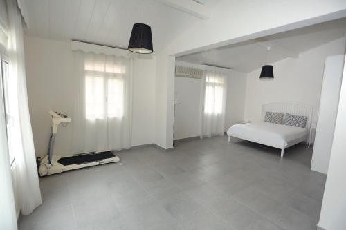 a white room with a white bed and a window at River & Sea Villa in Cesme
