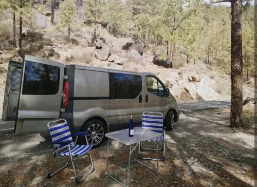 van zaparkowany obok stołu i krzeseł w obiekcie Autocaravana Camper w mieście Las Palmas de Gran Canaria