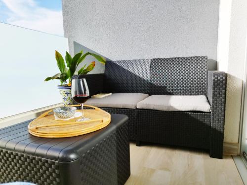 a table on a chair with a glass of wine at Amplio y cómodo apartamento. in Granadilla de Abona