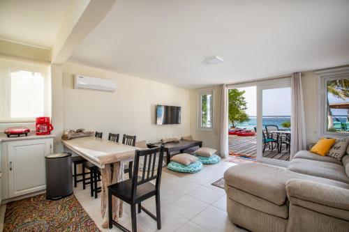 a living room with a couch and a table at Serene by the Sea in Savaneta