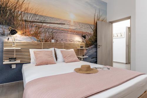 a bedroom with a bed with a hat on it at Villa Maro - Luxury Apartment in Naxos Chora