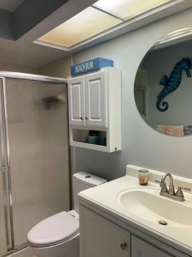 a bathroom with a toilet and a sink and a mirror at Beautiful Vacation Spot! in Beverly Hills
