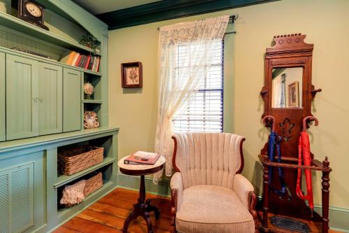 a living room with a chair and a window at Victorian Vacation Rental Apt in Downtown New Bern in New Bern