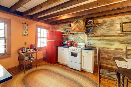 a kitchen with wooden walls and a white stove at Victorian New Bern Vacation Rental In Downtown! in New Bern