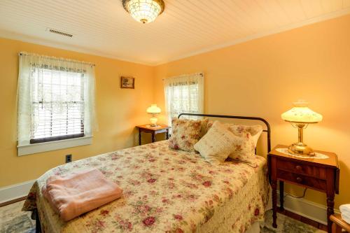 a bedroom with a bed and two windows at Victorian New Bern Vacation Rental In Downtown! in New Bern