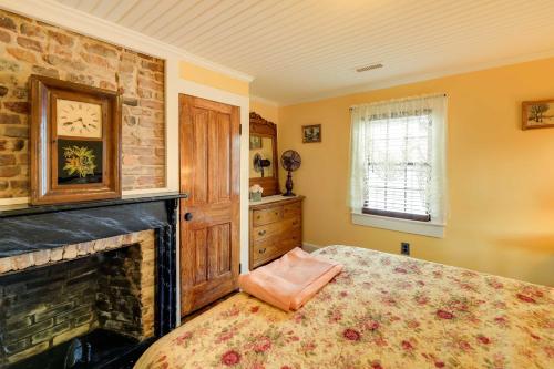 a bedroom with a large bed and a fireplace at Victorian New Bern Vacation Rental In Downtown! in New Bern