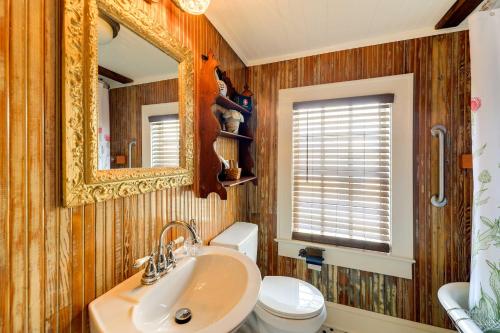 a bathroom with a sink and a toilet and a mirror at Victorian New Bern Vacation Rental In Downtown! in New Bern