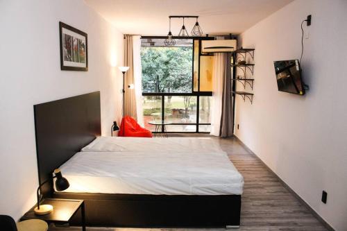 a bedroom with a bed and a large window at Exclusive on Rio Negro in Montevideo
