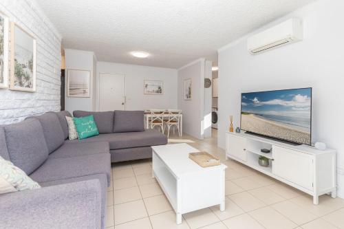 a living room with a couch and a tv at Mirabeau in Forster