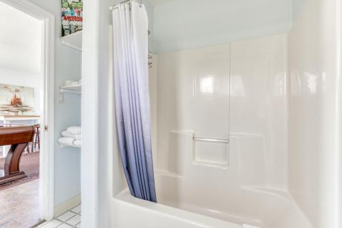 a bathroom with a shower with a shower curtain at Pearl off the Prom in Seaside