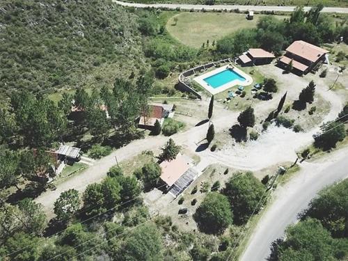 an aerial view of a house with a swimming pool at Cabañas Los Arroyitos in Potrero de los Funes