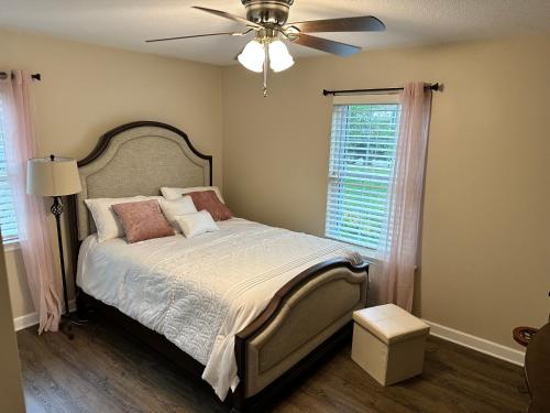 a bedroom with a bed with a ceiling fan at Brookwood in Chattanooga