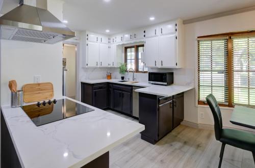 a kitchen with white cabinets and black appliances at Updated Spacious Home in Fresno