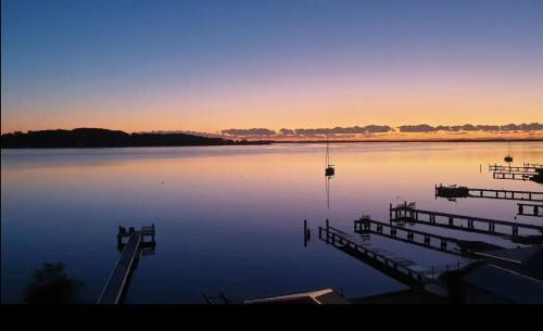a large body of water with a dock and boats at Sparkling Waters in Rathmines