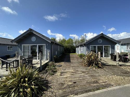 a house with a pathway in front of it at Sandy Collection - 2 next door beach houses - Part of the The Bay Filey Holiday Village with pool, gym and direct beach access, pub, restaurant, tennis and meadows walks in Filey