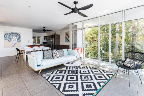 a living room with a couch and a table at Coastal Luxury, Private Pool, Ocean Vista in Sunshine Beach