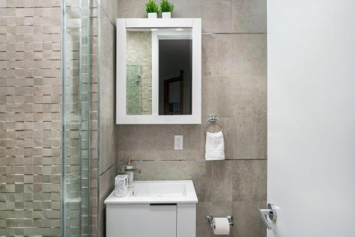 a bathroom with a sink and a mirror at 48-3RW Brand New 1BR Prime Hells Kitchen - W D in New York