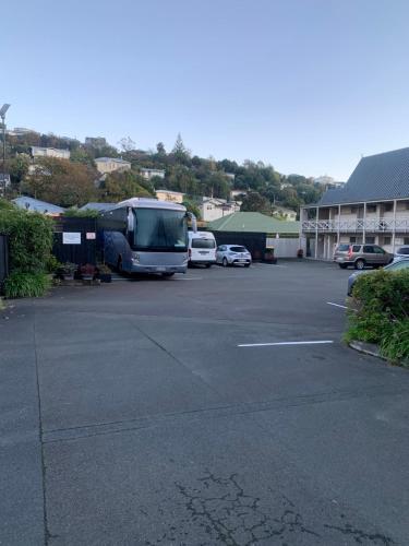 a van parked in a parking lot in front of a building at Admirals Motor Inn in Nelson