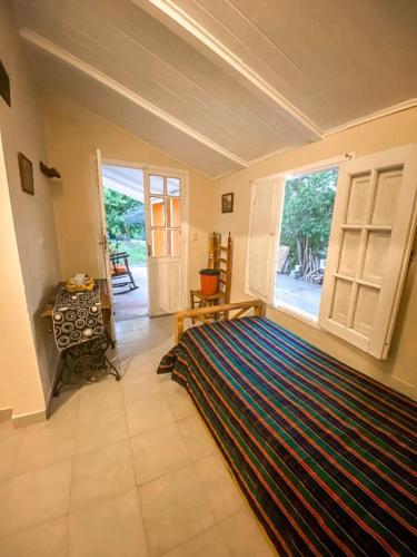 a bedroom with a large rug on the floor and a large window at Departamento Sofía in Tanti