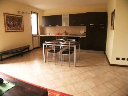 a kitchen with a table and chairs in a room at Corte Nuova in Valeggio sul Mincio