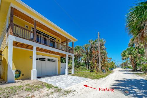 a house with a balcony and a driveway at Lovely Guesthouse Loft with Balcony and Hammock STEPS from the Beach! in New Smyrna Beach