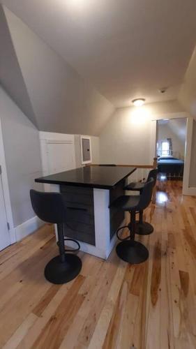 a dining room with a black table and chairs at Guest suite in historical district in Gloucester