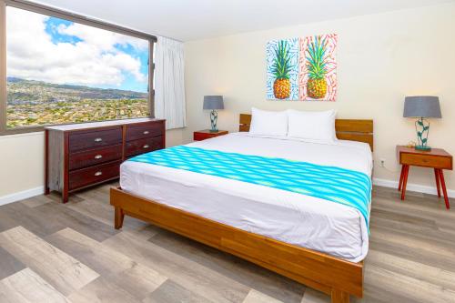 a bedroom with a large bed and a large window at Panoramic Mountain View Condo with Free Parking! in Honolulu