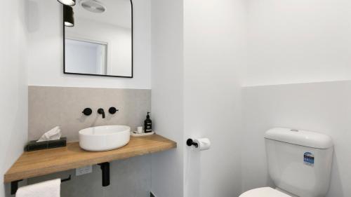 a bathroom with a sink and a toilet and a mirror at 32 Plateau in Metung